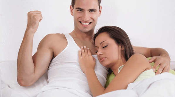 sieviete gultā ar vīrieti, kuram ir paaugstināta potenci
